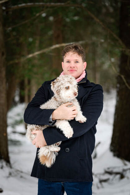 Dr. Michel Gallant with his dog in a winter forest